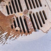 water-draining-into-a-sewer-manhole-after-rain-on-2023-11-27-05-11-28-utc_11zon